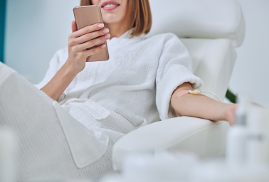 Woman receiving an IV drip treatment in a relaxed clinical setting